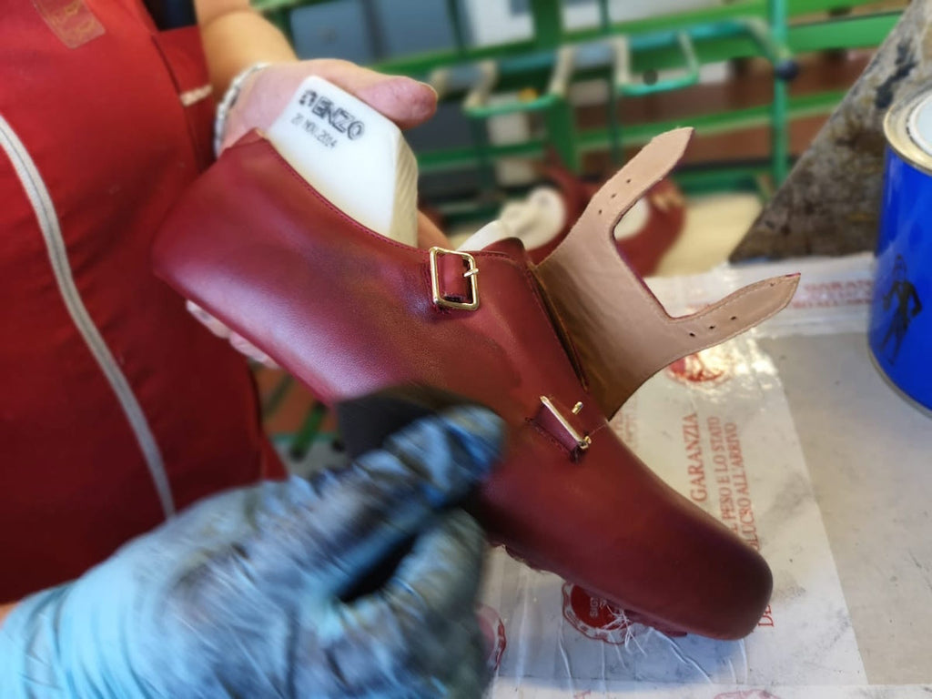 Artisan polishing red sneaker