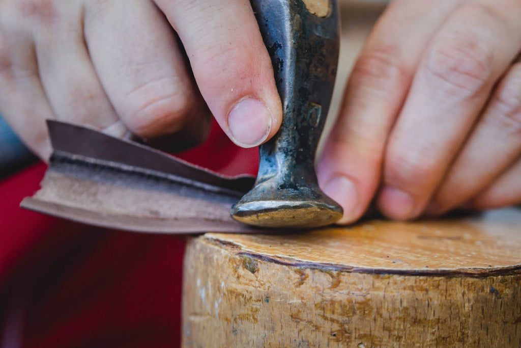 Artisan hammering leather for shoe making