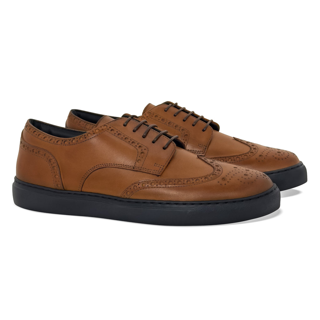 Women's cognac leather brogue wingtip dress sneaker - angle view