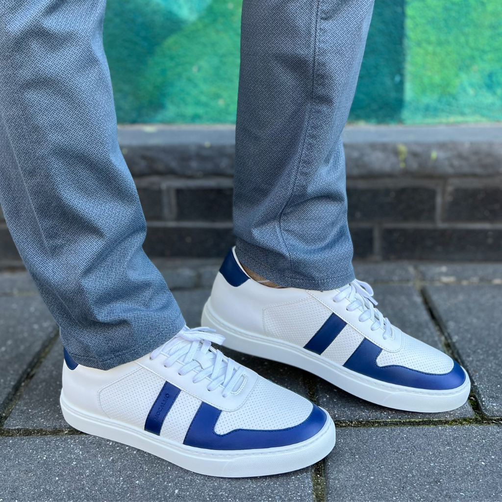 Man wearing blue and white sneakers with nice blue pants