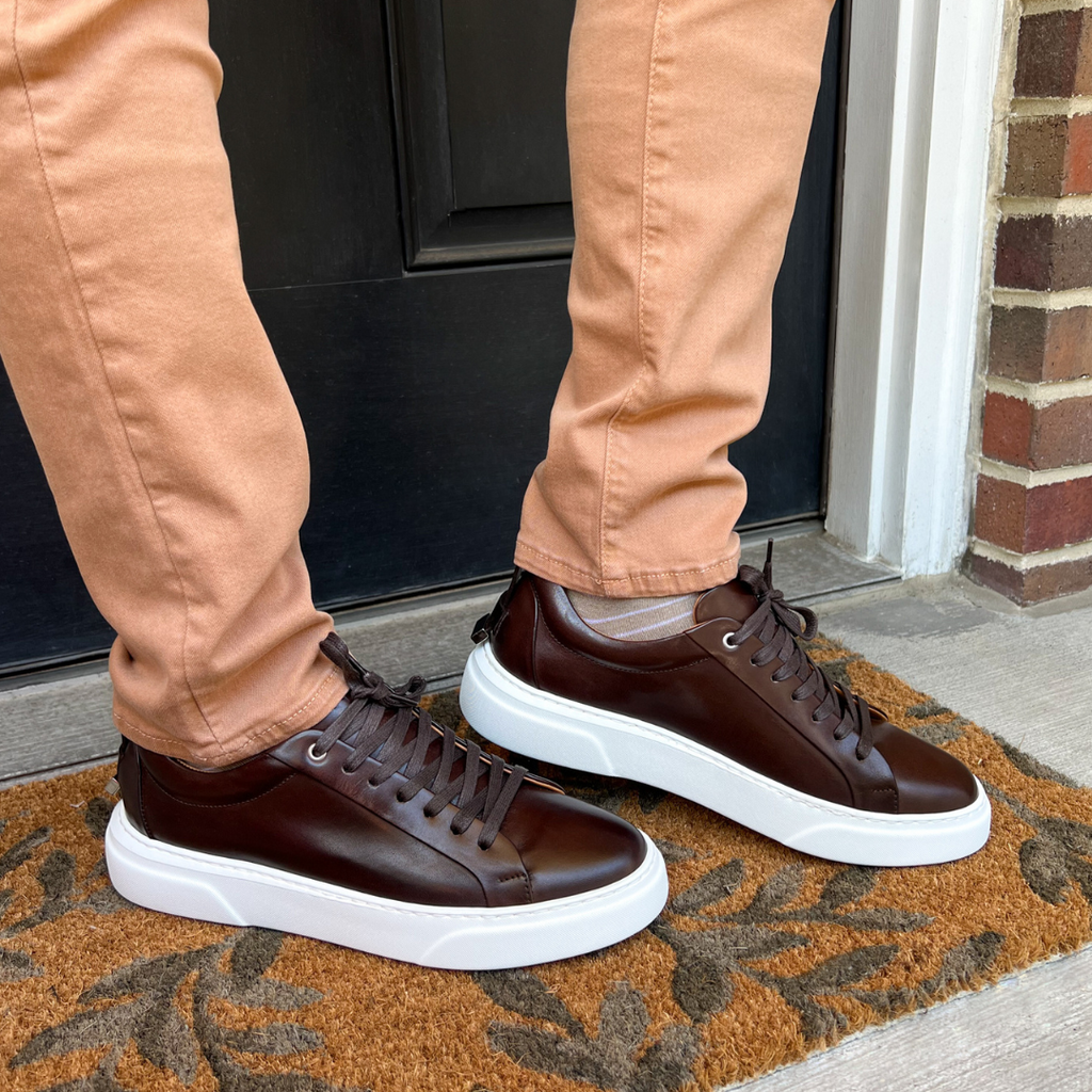 Man wearing fashionable brown sneakers