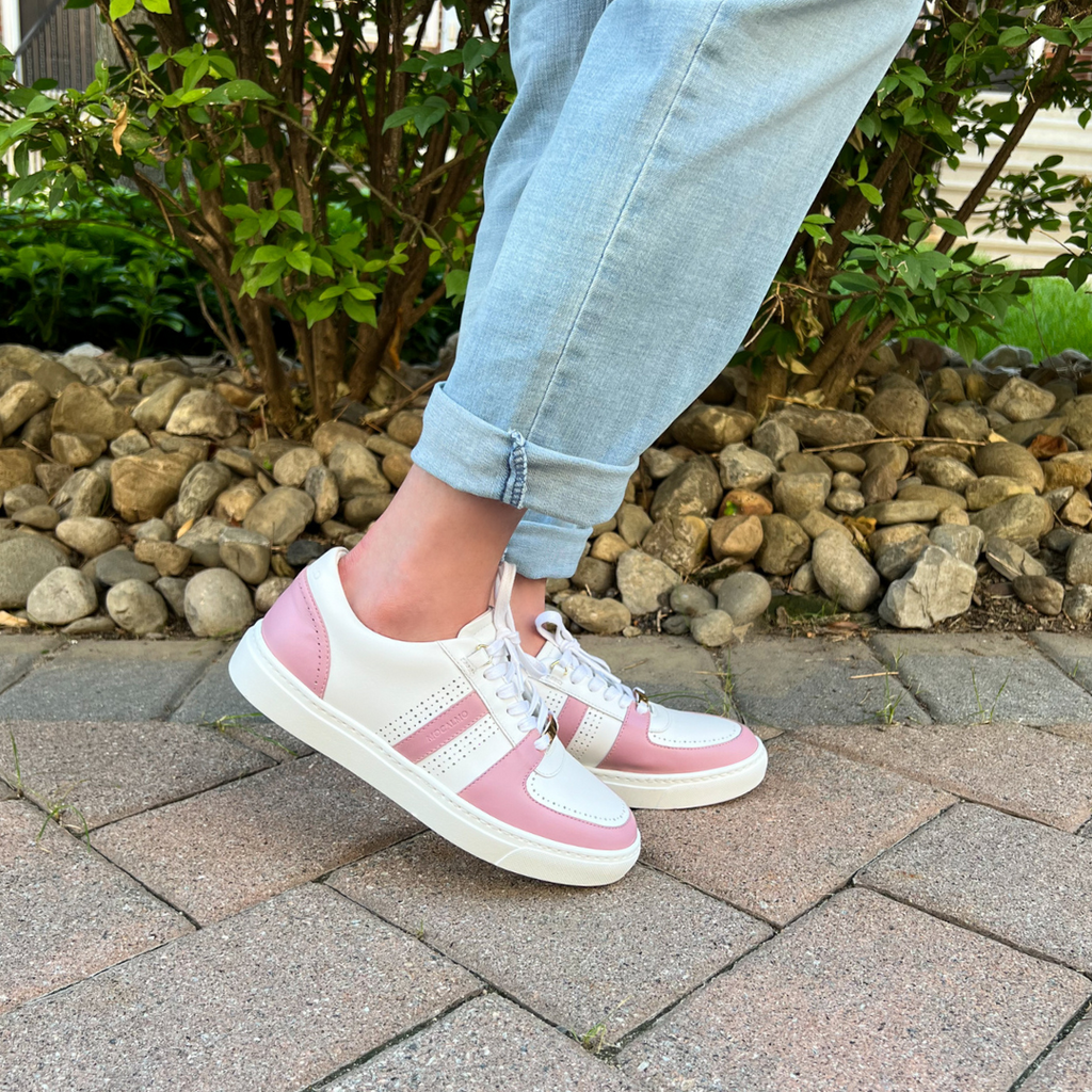 Woman wearing pink and white sneakers