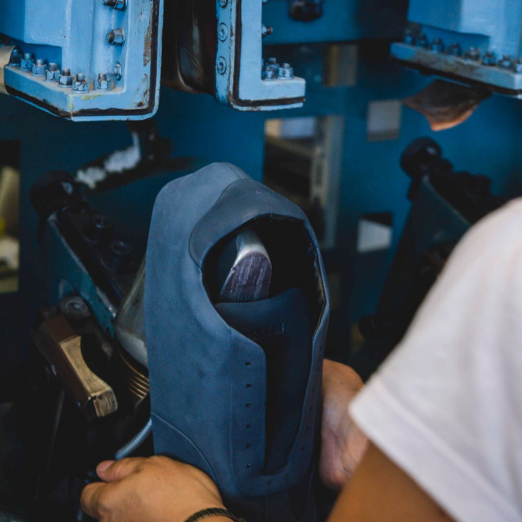 Artisan in Italy making blue leather dress sneakers