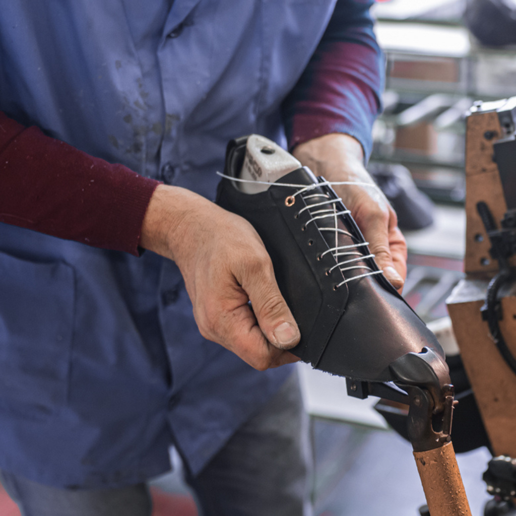 Artisan in Italy making black stylish leather sneakers