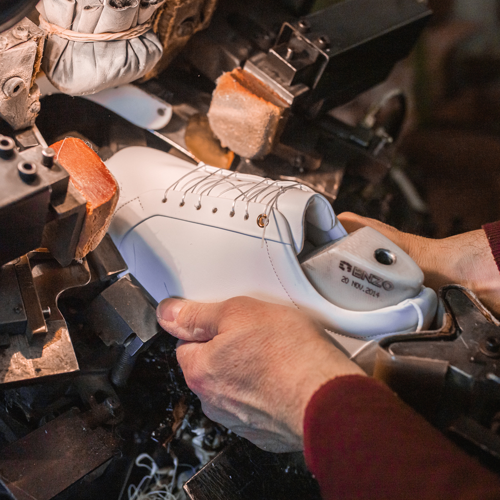 Artisan in Italy making stylish white leather sneakers