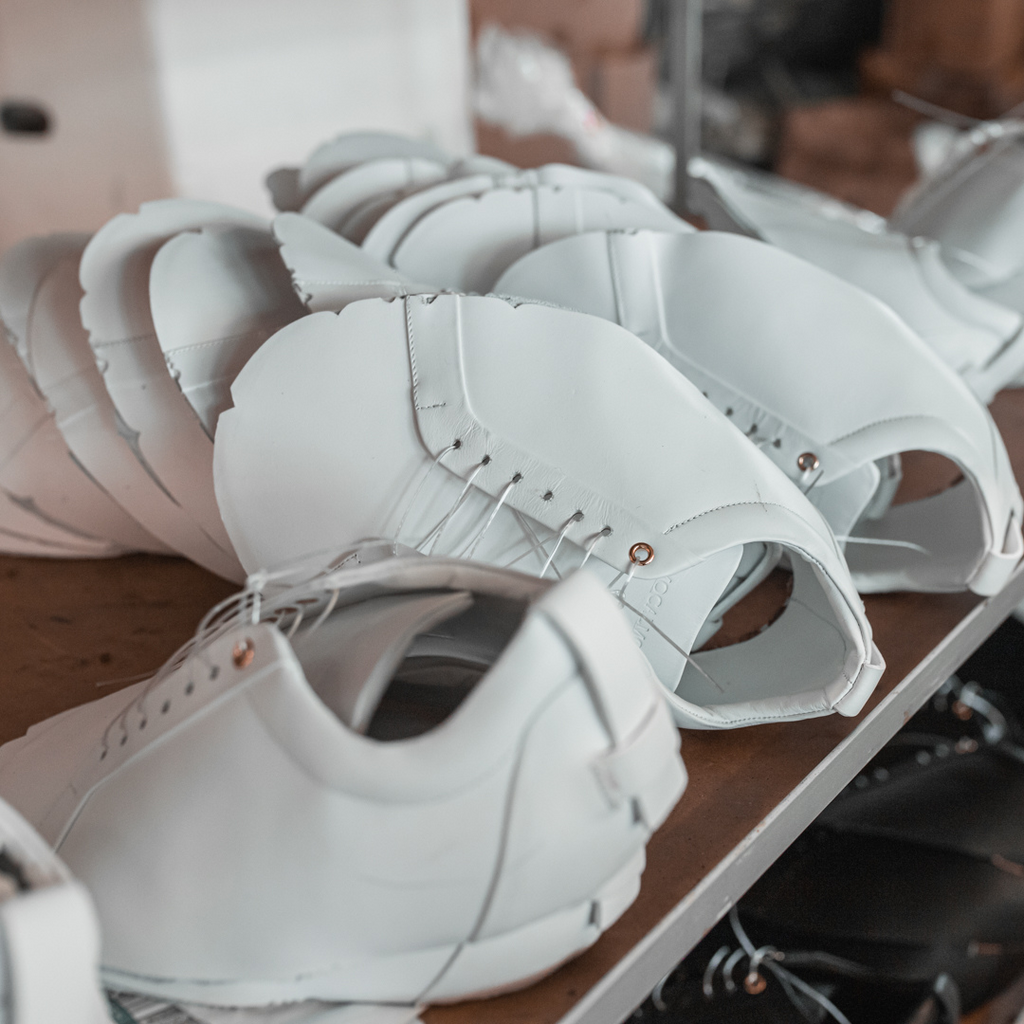 Artisan in Italy making stylish white leather sneakers