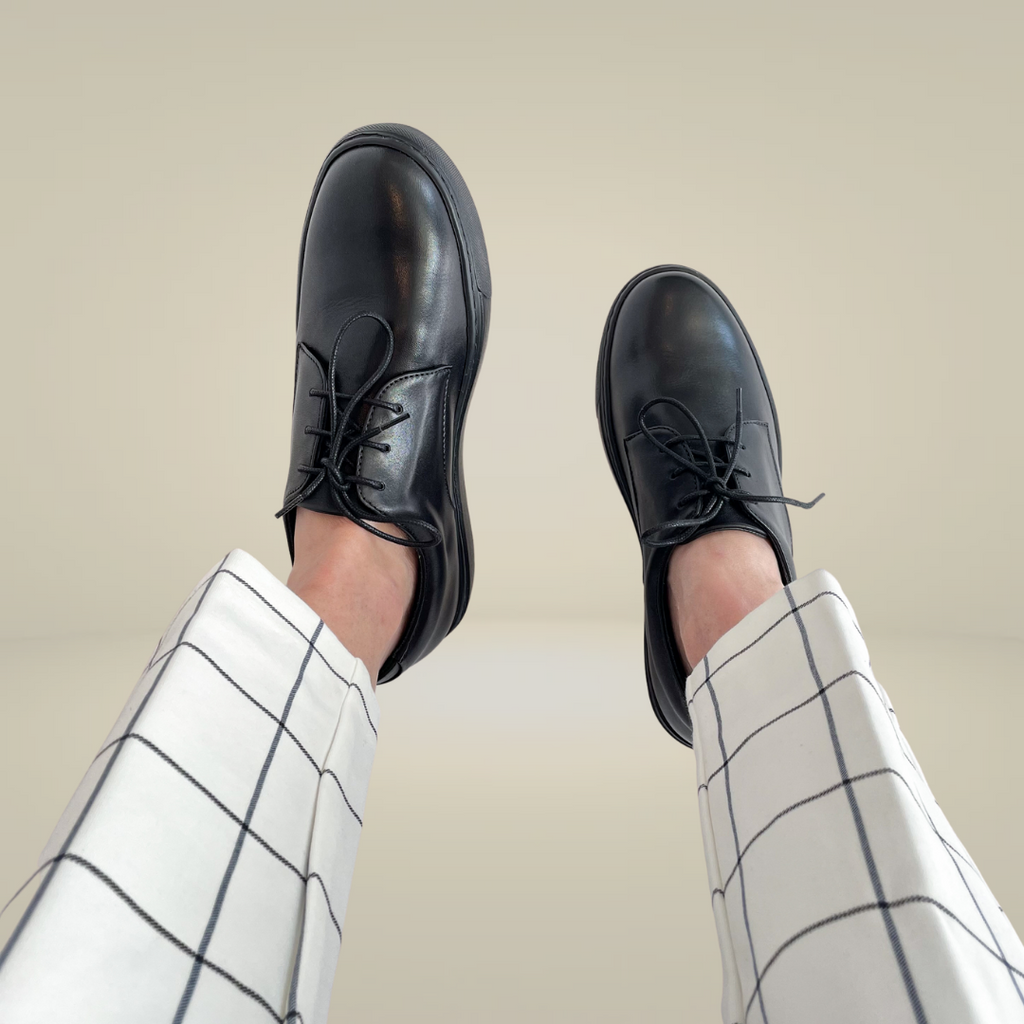 Woman wearing comfy black sneakers at work