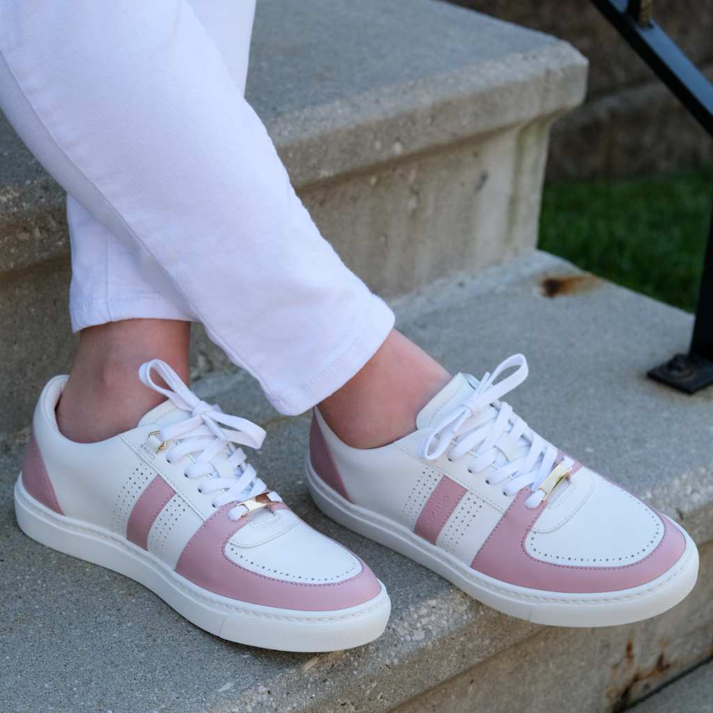 Woman wearing stylish rose pink white sneakers